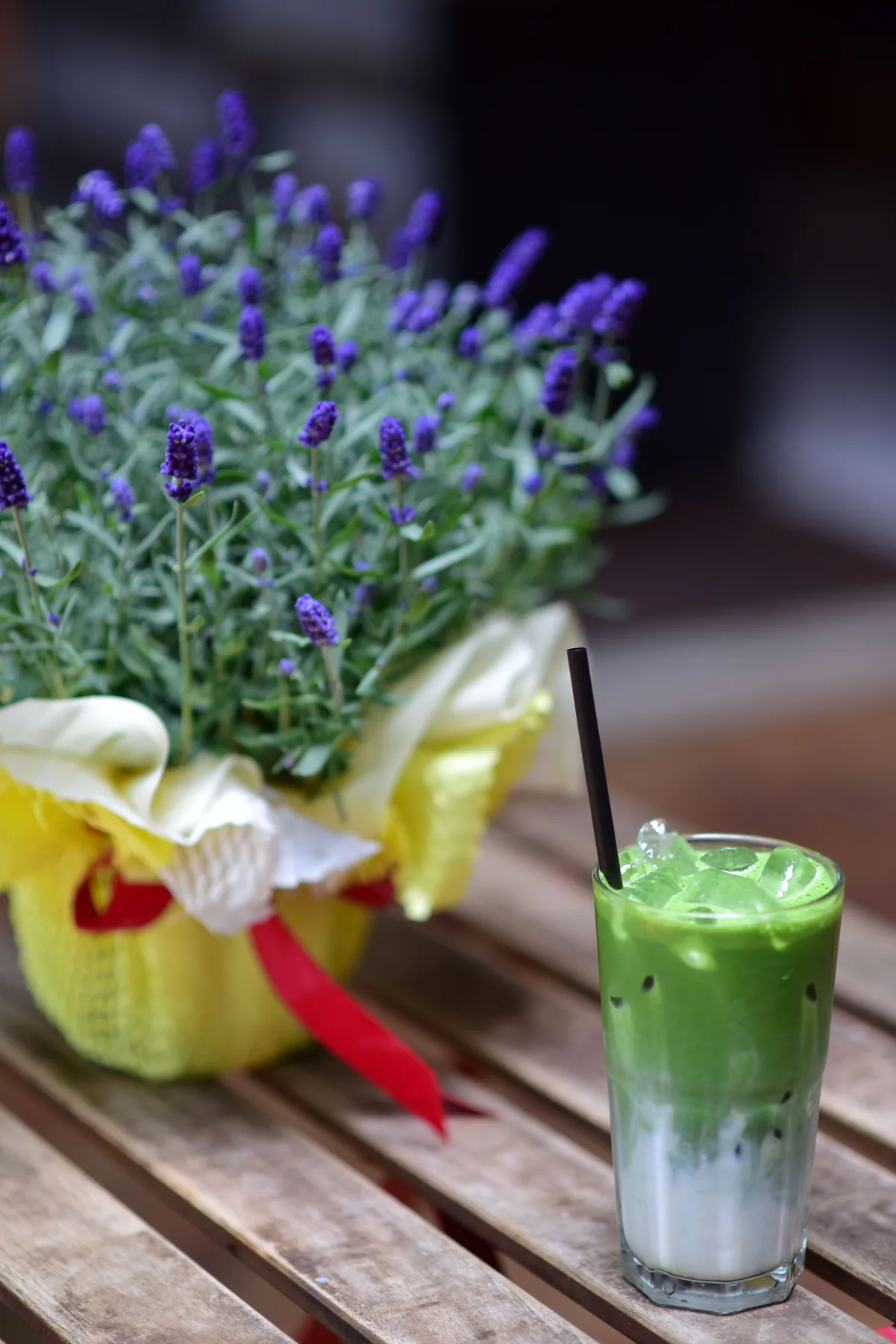 Iced matcha latte beside lavender
